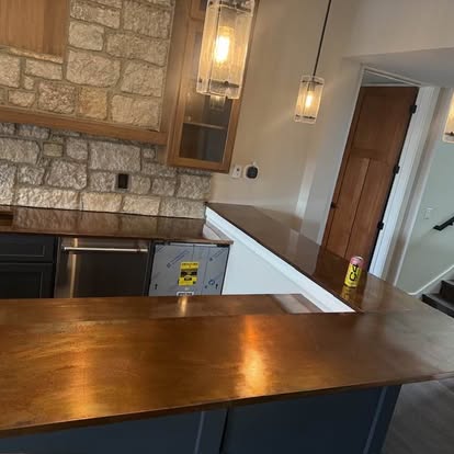 Copper countertop installed in a stone-walled kitchen