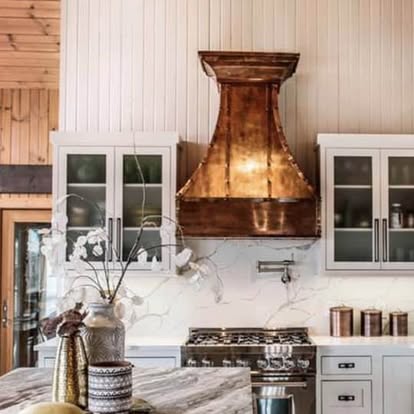 Hammered copper range hood with strap and rivet detailing
