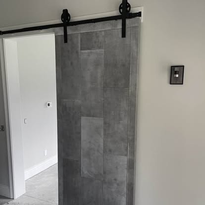 Custom zinc-finish sliding barn door with black hardware